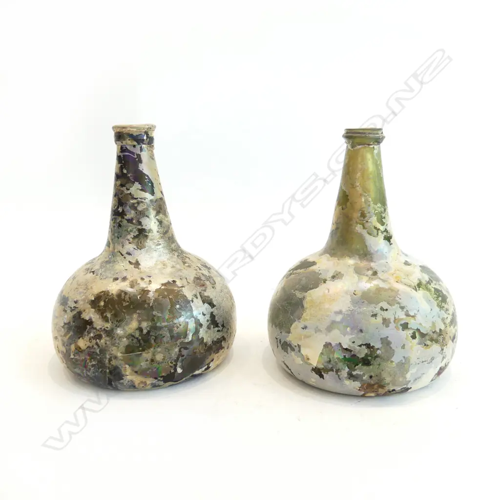 A pair of Dutch or English 17thC onion wine bottles with rich iridescent patina. Image 1++