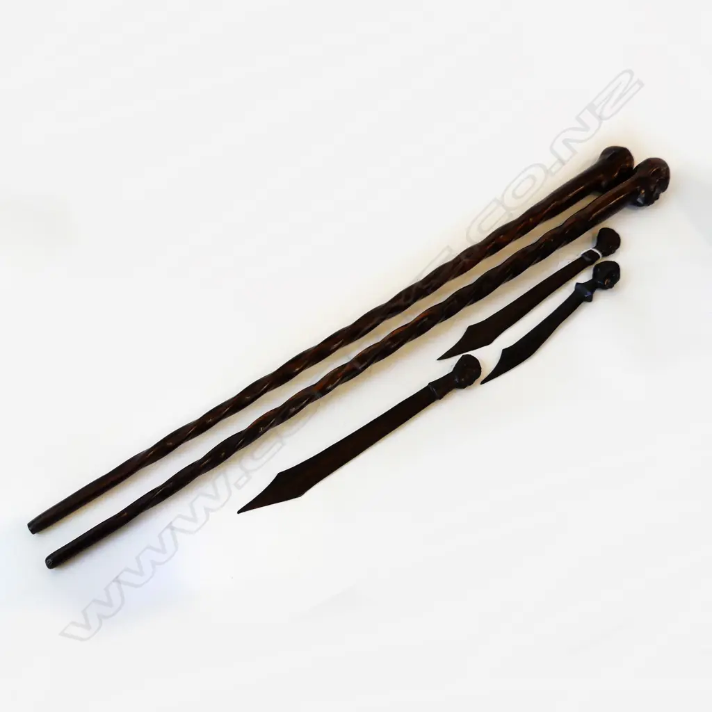 FIVE CARVED ZEBRAWOOD ITEMS. TWO BARLEy TWIST WALKING STICKS L.940mm & THREE LETTER OPENERS ALL WITH MALE HEAD FINIALS. Image 1++
