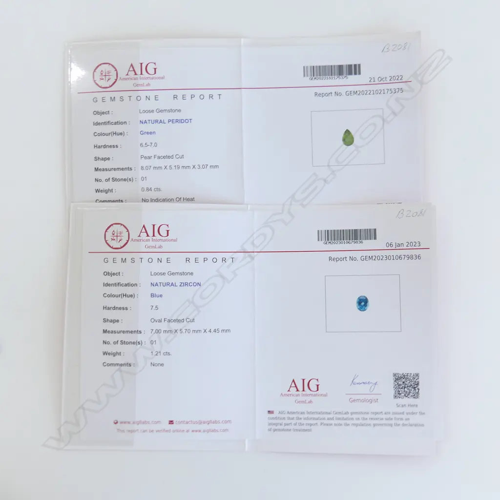 2 GEMS, 1 PEAR CUT PERIDOT & 1 BLUE ZIRCON BOTH WITH AIG CERTS Image 1++