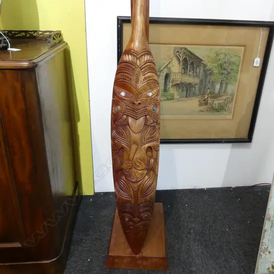 WAKA HOE; MAORI CARVED WOODEN ORNAMENTAL CANOE PADDLE L.1510mm ON STAND H.870mm