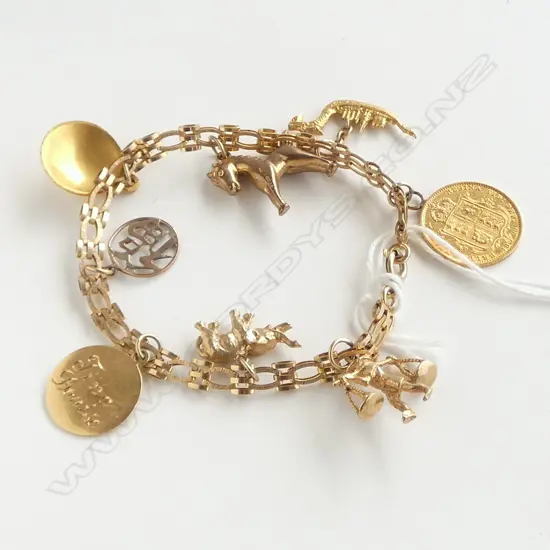 9CT GOLD CHARM BRACELET WITH 18CT/9CT CHARMS AND A VICTORIAN HALF SOVEREIGN 22gm