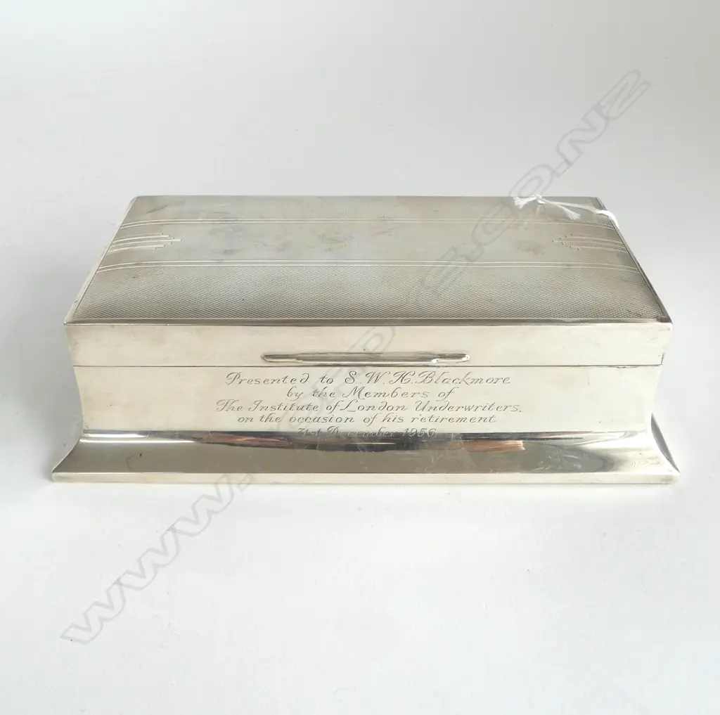 A mid 20thC silver presentation large cigarette box with fine machine engraving. Sheffield 1955. Walker & Hall. 749gms. Cedar lined. L.200mm. Image 1++