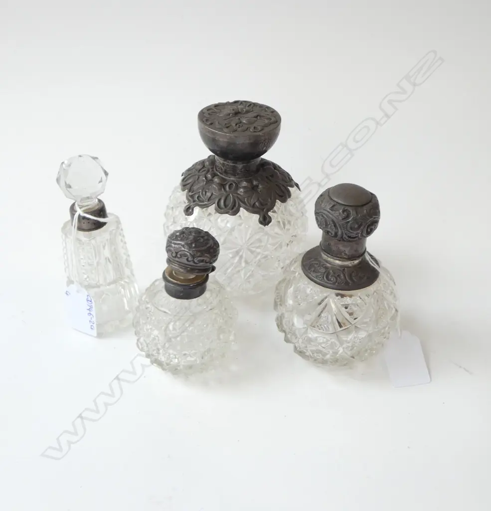 4 EARLY 20thC EMBOSSED STG SILVER TOPPED SCENT BOTTLES H.130mm (1 NEEDS REPAIR) Image 1++