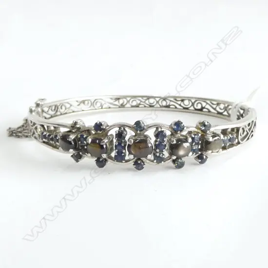 HINGED SAPPHIRE BANGLE stamped 18ct but unlikely