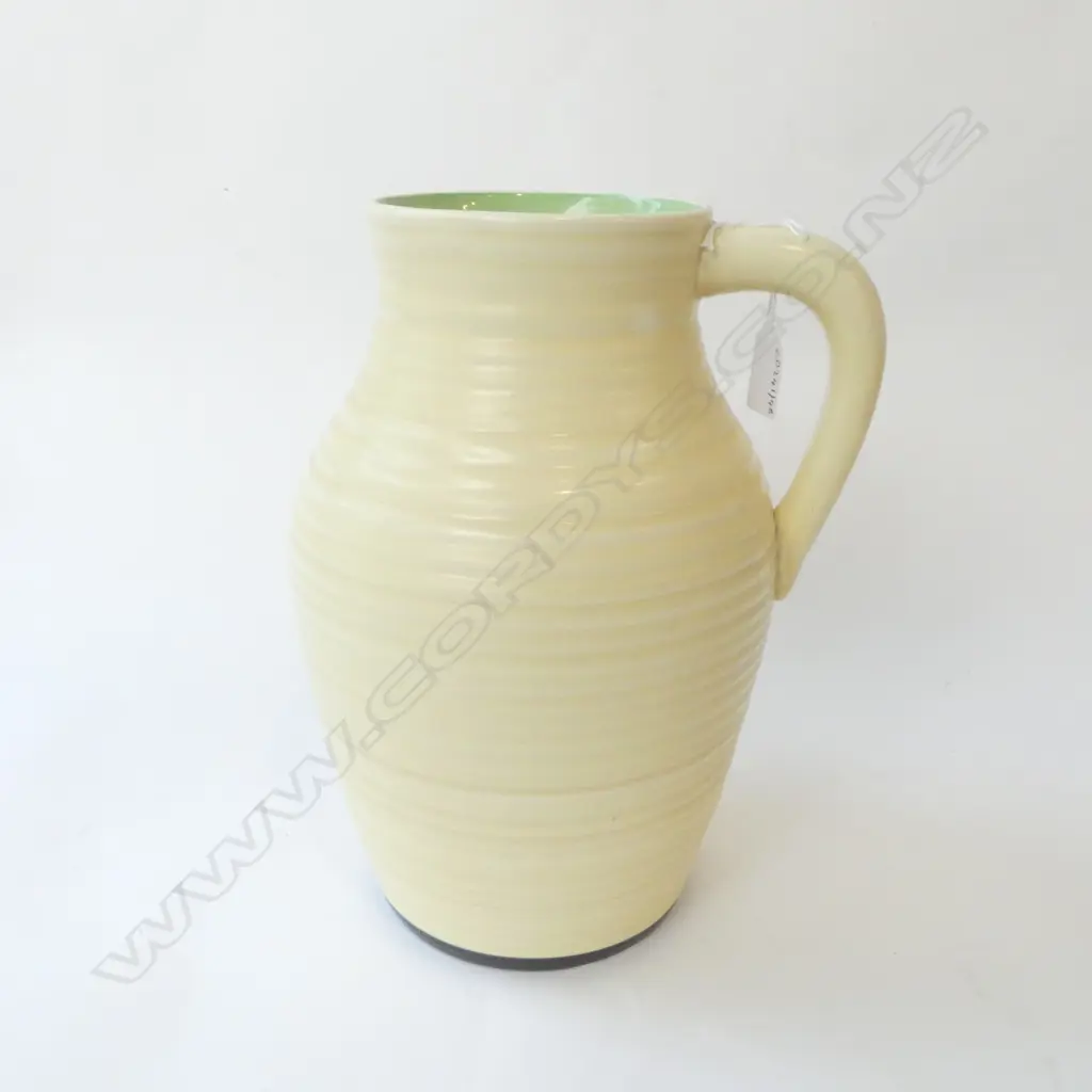 LARGE CLARICE CLIFF LOTUS JUG single handled. Ribbed design plain cream green to interior rim H.300mm Image 1++