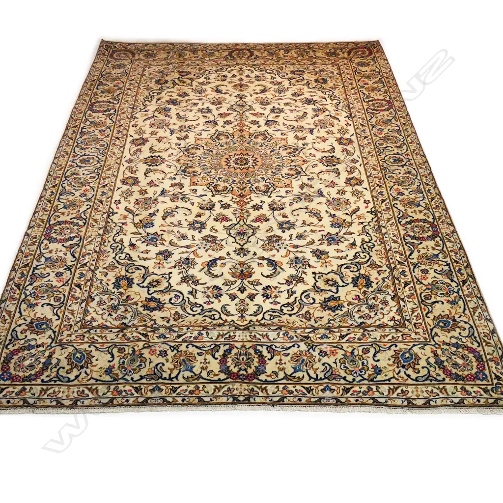 A fine quality hand-knotted Kashan carpet, the field decorated with multi-coloured flowering leafy tendrils surrounding a central medallion, on an ivory ground, multiple border guards with conforming decoration. 3400 x 2450mm. Image 1++