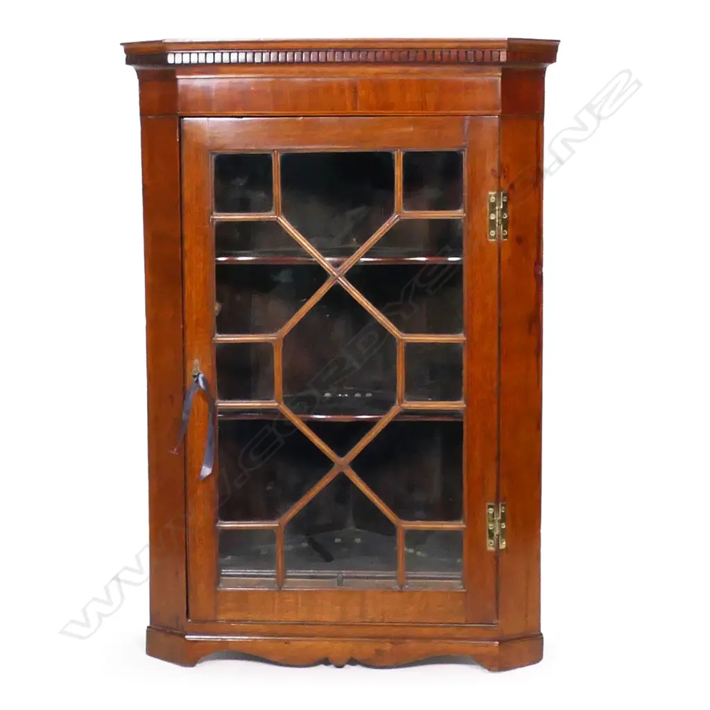 A Georgian mahogany corner cupboard - astragal glazed door, the interior with two shelves, H.form brass hinges and dentil decoration to pediment. 710 x 400 x 1060mm. Image 1++