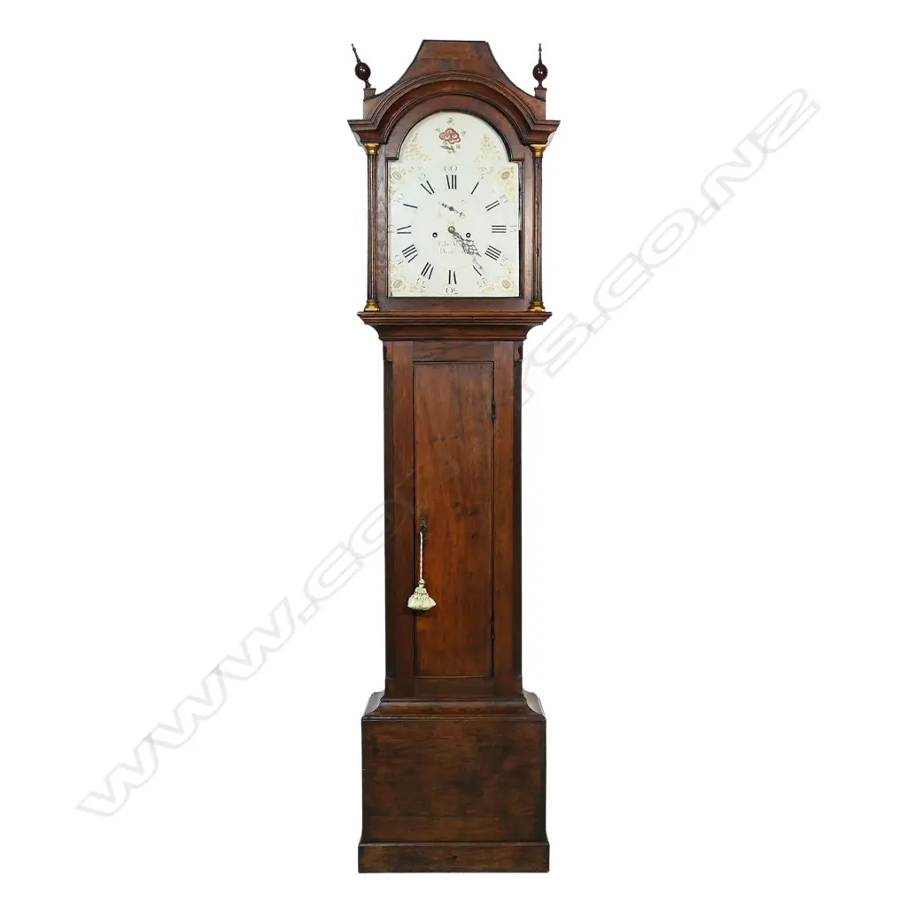 A Georgian oak long case clock - the hood with two finials, (one absent), reeded column with brass detail to each side, the dial with painted floral decoration, Roman numerals with the minutes in Arabic numerals, seconds dial, marked Edwd. Maud, Daventry, chamfered sides to case. 460 x 240 x 2600mm. Image 1++