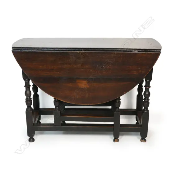 A George III country oak gate leg table - the drop sides raise on turned supports. 1120 x 1060 x 750mm.