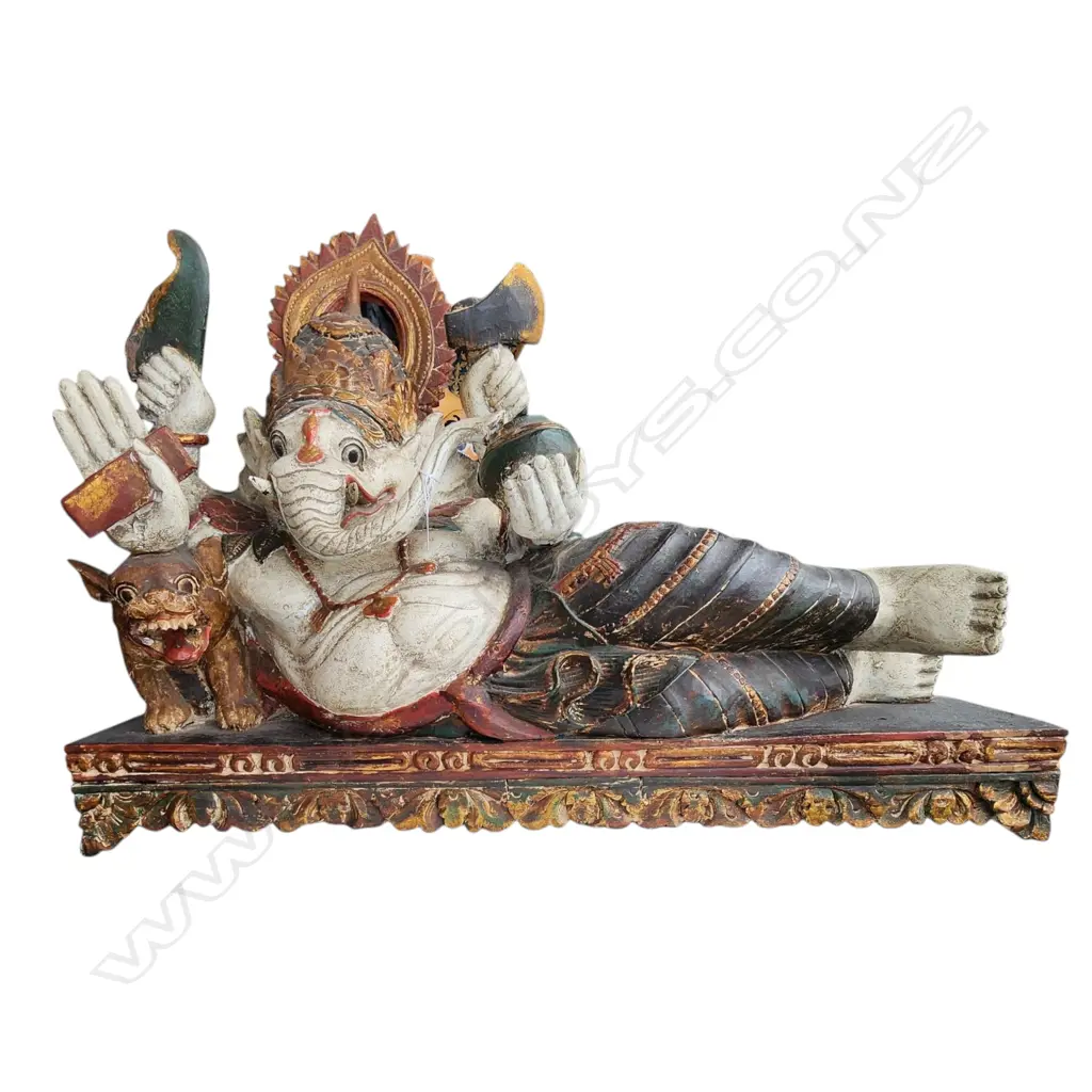 LARGE CARVED & PAINTED FIGURE of the revered deity GANESH lying upon a throne with tiger & sacred objects. L.1000mm Image 1++