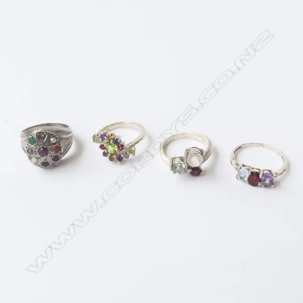 FOUR SILVER & COLOURED STONE RINGS Image 1++