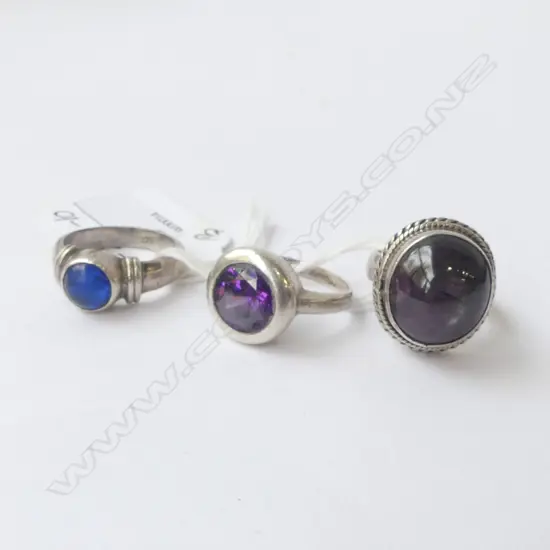 THREE SILVER & COLOURED STONE RINGS