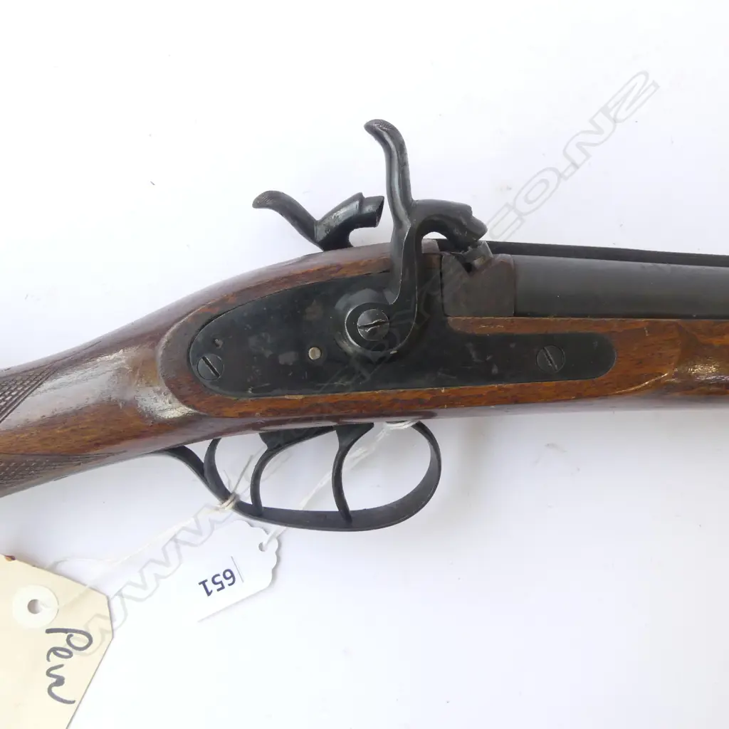 Modern Spanish Repro 20g Muzzle loading D/B percussion shotgun. 27.5" barrels, good bores with minor rust specking. Tight action. C/w wooden ramrod. Good varnished wood work with checkering at wrist. Has brass percussion cap holder built into R/H side of butt. S/N 27008. FC. Provenance: NZ Antique Arms, 21/07/2004, Lot 1456. $251.42. Fire Arms License Required. Image 1++