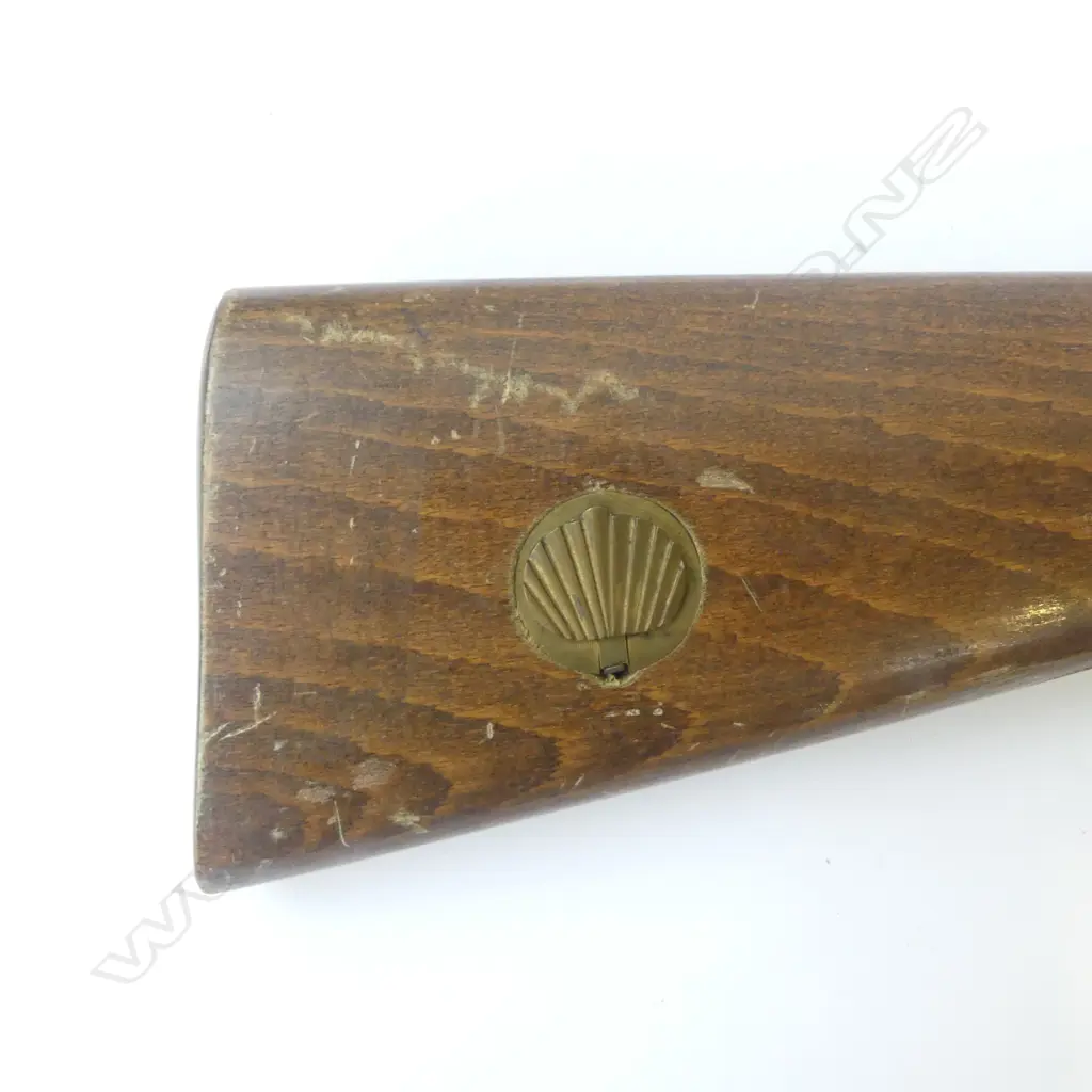 Modern Spanish Repro 20g Muzzle loading D/B percussion shotgun. 27.5" barrels, good bores with minor rust specking. Tight action. C/w wooden ramrod. Good varnished wood work with checkering at wrist. Has brass percussion cap holder built into R/H side of butt. S/N 27008. FC. Provenance: NZ Antique Arms, 21/07/2004, Lot 1456. $251.42. Fire Arms License Required. Image 1++