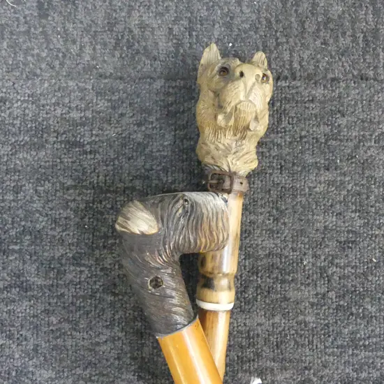 2 vintage CARVED WOOD DOG HEAD WALKING STICKS  with wooden shafts