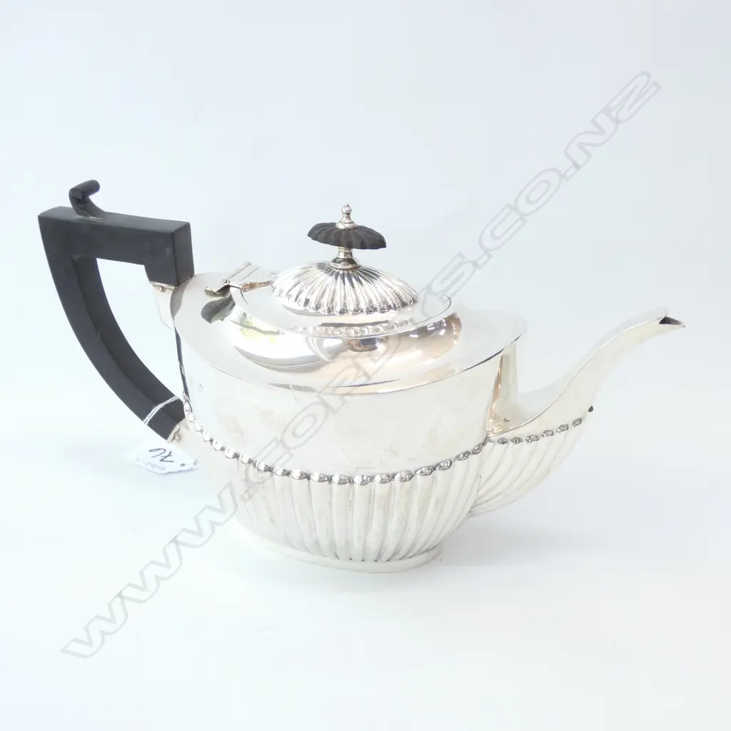 Silver teapot with half lobed body. Birmingham 1916 by William Aitken. 362gms. Image 1++