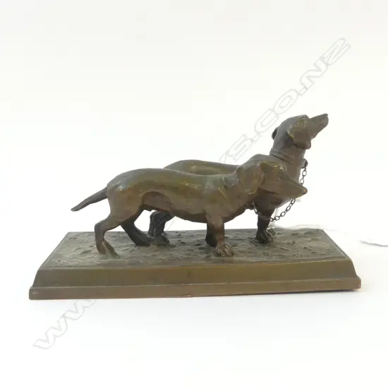 BRONZED WHITE METAL SCULPTURE OF TWO DASHOUNDS on rectangular base. L.155mm