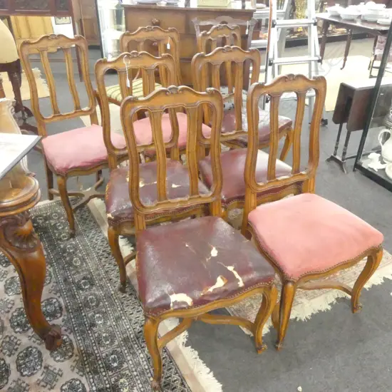 7 CARVED UPHOLSTERED DINING CHAIRS (FAULTS TO FABRIC)