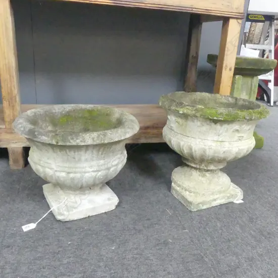 2 CONCRETE GARDEN URNS; TALLEST H.360mm & FLEUR DE LIS MOTIF - OTHER WITH CRACK 
