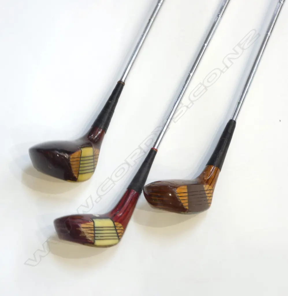 THREE 'SPALDING' RIGHT HANDED GOLF CLUBS. Two cream and one brown coloured Catalin faced fairway woods with wood grained heads and metal soles. Good condition clubs with steel shafts and grips Image 1++