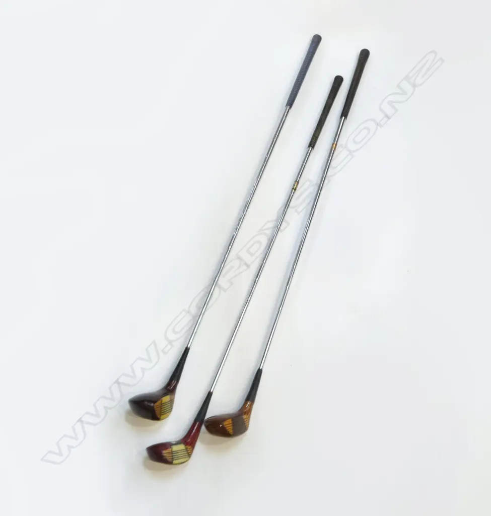 THREE 'SPALDING' RIGHT HANDED GOLF CLUBS. Two cream and one brown coloured Catalin faced fairway woods with wood grained heads and metal soles. Good condition clubs with steel shafts and grips Image 1++