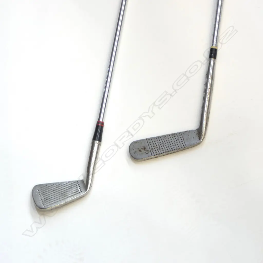 TWO VINTAGE GOLF CLUBS. A vintage “Andy McCallum” steel shafted flat-stick putter number 9 with a leather grip and wooden butt-cap. Rust spotting to putter-head Image 1++