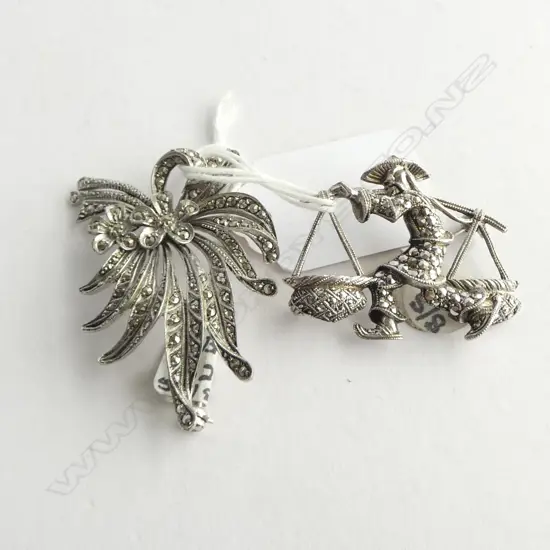2 SILVER & MARCASITE FLORAL SPRAY BROOCHES 1 as an oriental figure carrying baskets