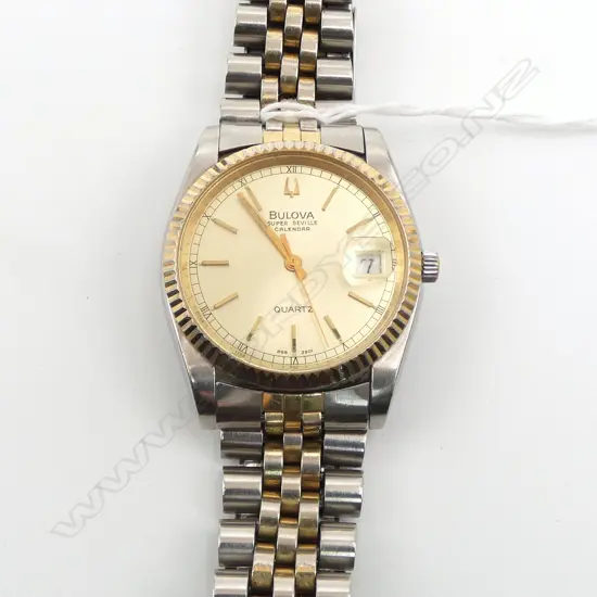 VINTAGE BULOVA SUPER SEVILLE CALENDER GENT'S GOLD PLATE & stainless WRISTWATCH w stainless strap. c.1980. Working