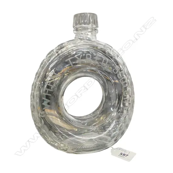 AN EARLY 20THC NOVELTY WHISKY DECANTER IN THE FORM OF A TYRE (no stopper and some chipping to rim)170 x 200mm