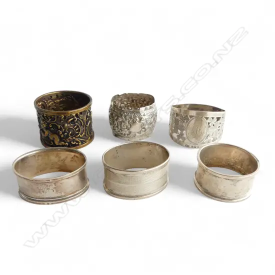 6 OLD SILVER NAPKIN RINGS: 1 gilded w cherubs. 130gms 