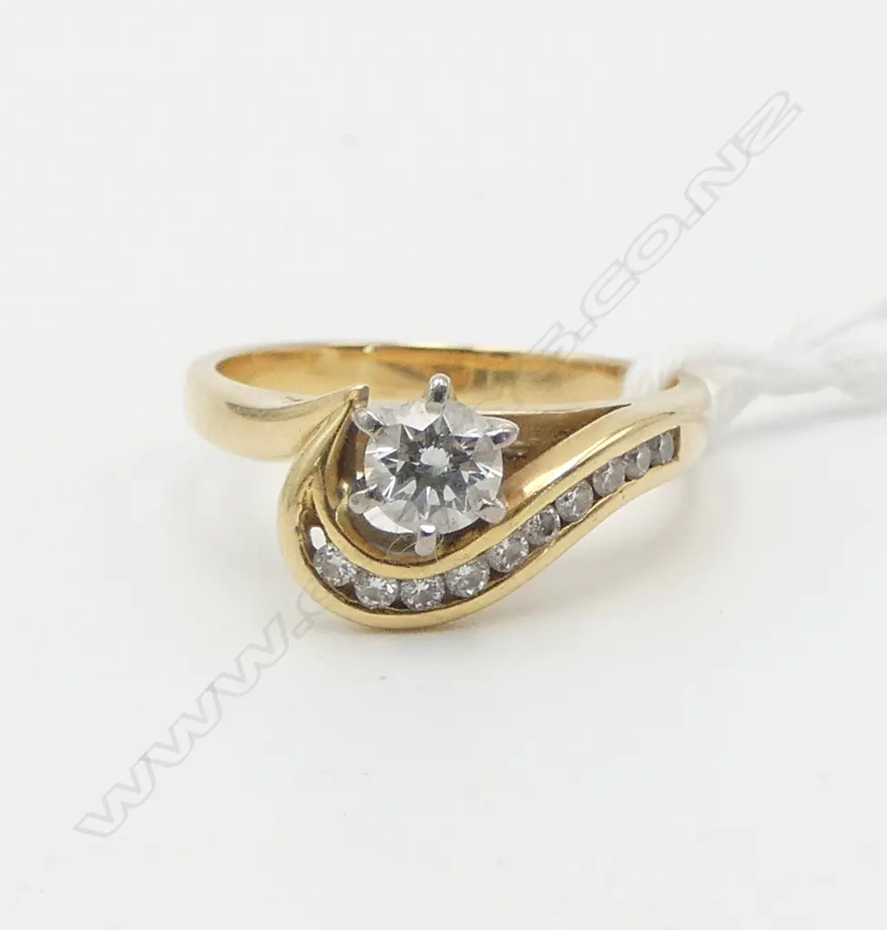 18ct YELLOW GOLD 0.34ct DIAMOND SOLITAIRE RING (H/I SI1) with a swirling mount set with small diamonds 4.8gms,  (Diamond Image 1++