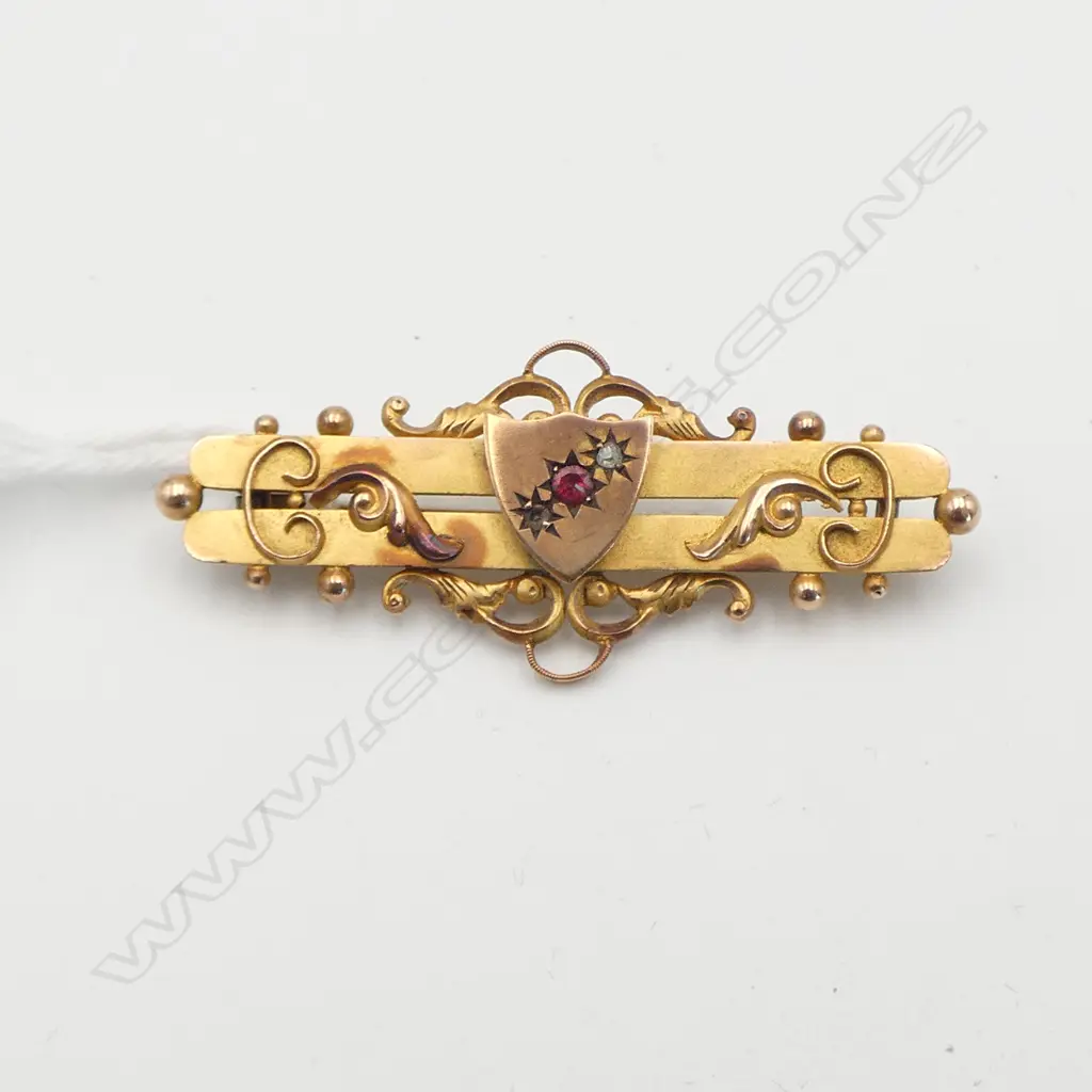 VICTORIAN 9CT AND RUBY BAR BROOCH one diamond missing Image 1++