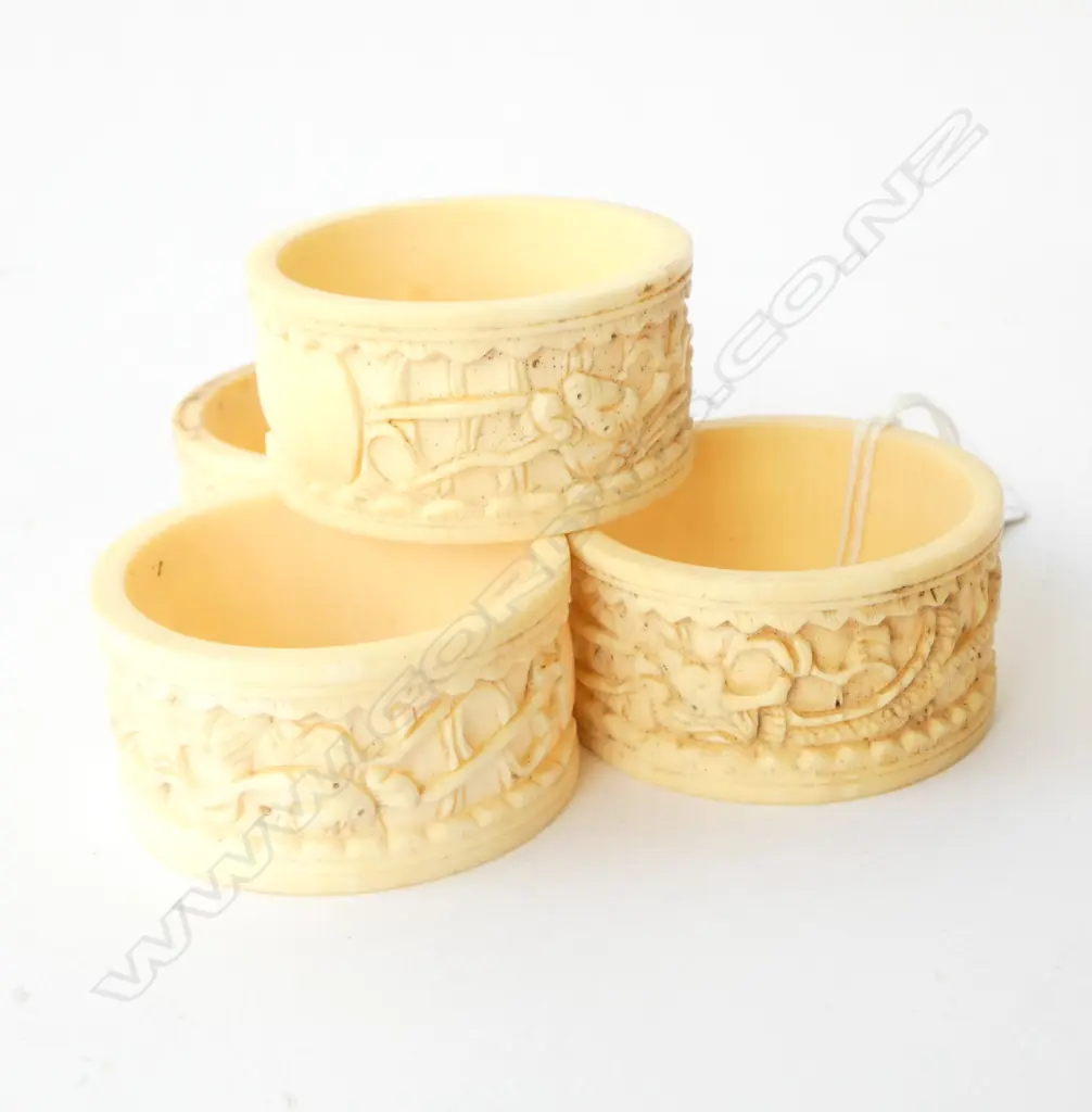 4 CARVED IVORY NAPKIN RINGS Image 1++
