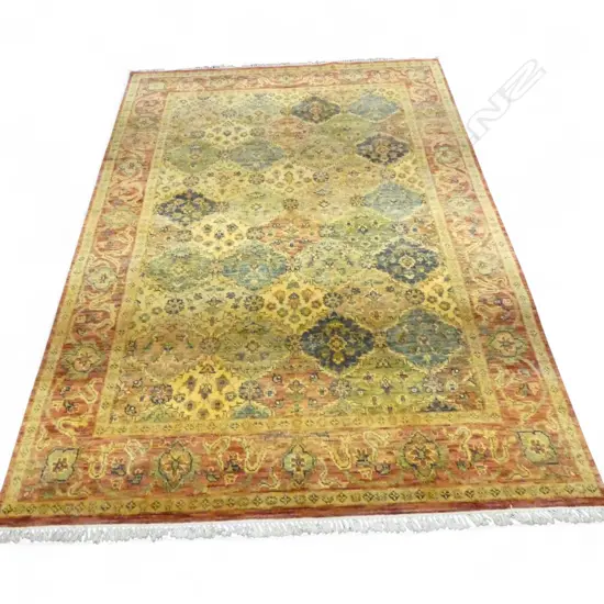 A Persian Kerman hand knotted pale tone rug,