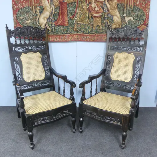 PR EARLY 20thC HEAVY SOLID CARVED EBONY ANGLO INDIAN PARLOUR ARM CHAIRS WITH WYCOMBE CANE with loose cushions
