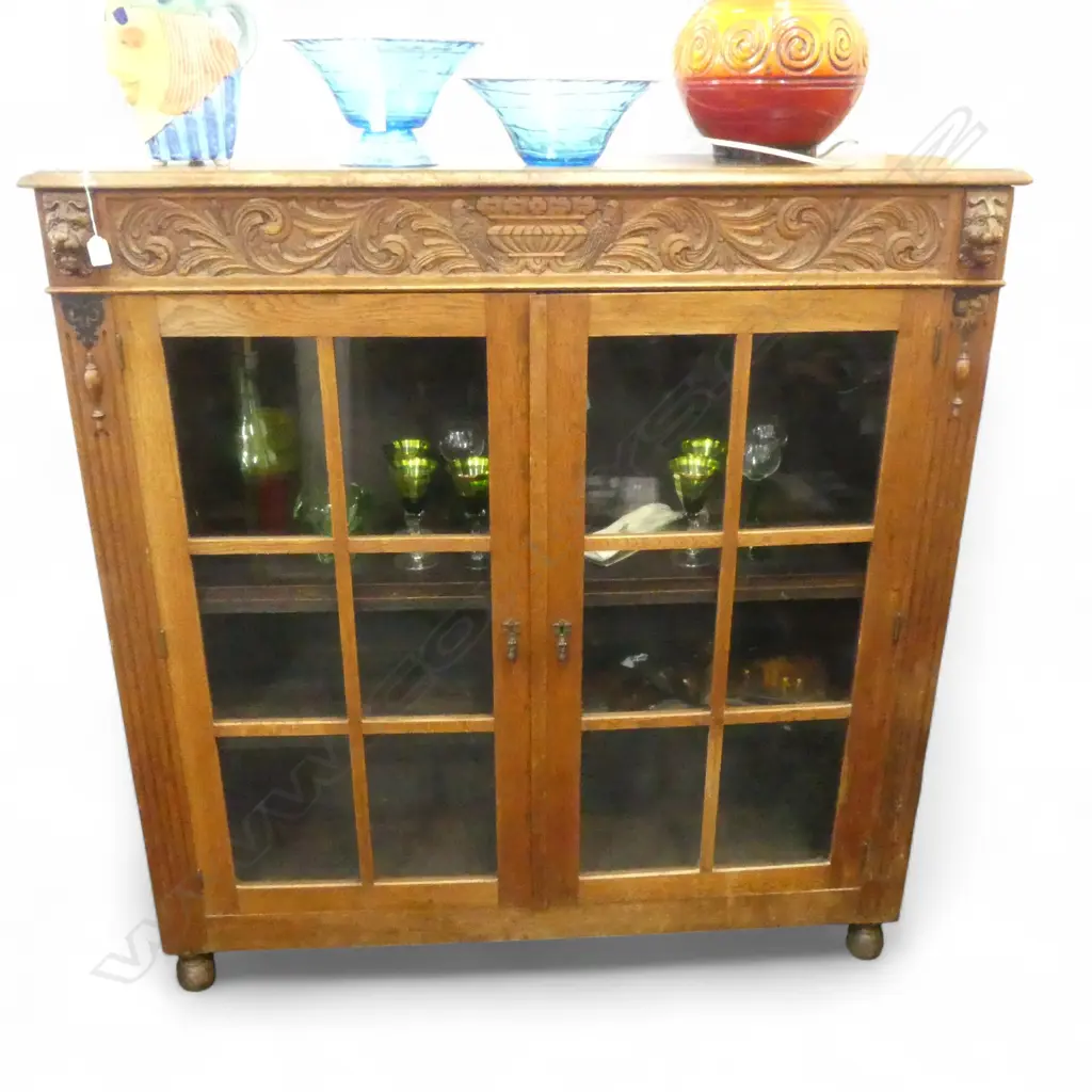 C1900 EUROPEAN OAK DISPLAY CABINET panelled dble doors. Lion mask + bird + flowering urn detail. Image 1++