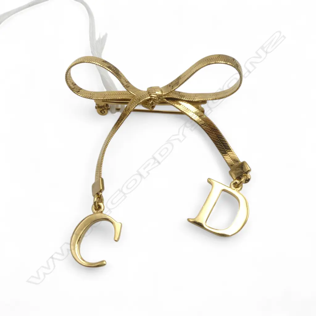 CHRISTIAN DIOR GOLD TONE BOW BROOCH purchased from DFS Akld. Image 1++