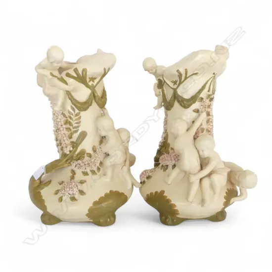 A CERAMIC FIGURAL VASE DEPICTING PUTTI AND FLORAL GARLANDS 470 mm (H) 