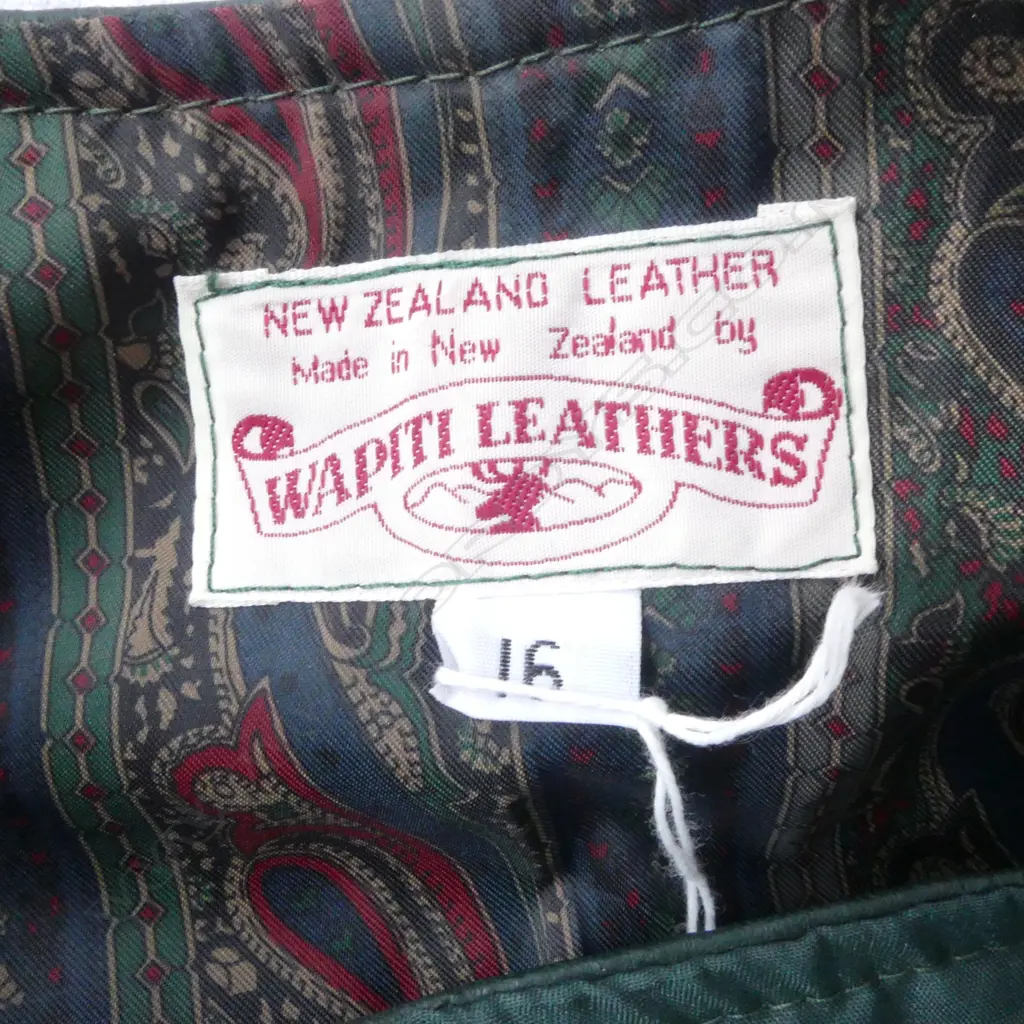 'WAPITI LEATHERS' NZ vintage 2 piece green leather lady's outfit: skirt & long vest. Size 16. Buttoned detail to skirt.  Image 1++