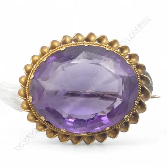 9CT GOLD AND AMETHYST BROOCH with valuation, repairs