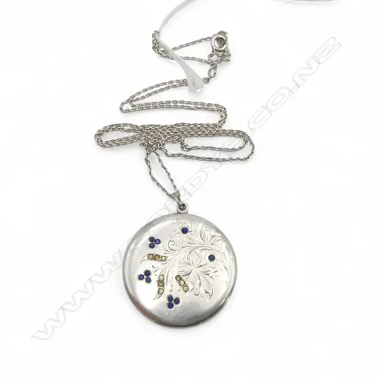 Silver locket inlaid with blue stones