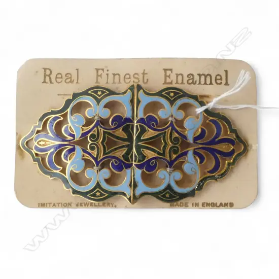 An Edwardian green & blue scrolling belt buckle on original card backing. New old stock. L.120mm