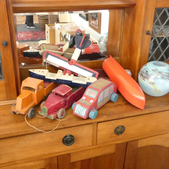 7 PAINTED WOODEN TOYS; 2 TRUCKS, 3 BOATS, BI-PLANE, CAR L.395mm