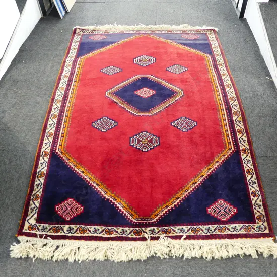 **RTV** PERSIAN QASHQAI ALL WOOL RUG; 6 central medallions on plain red lustre ground 1830x1130mm