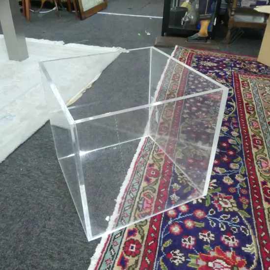 A CLEAR PERSPEX CUBE WITH TWO OPEN SIDES 340 X 340 X 340MM