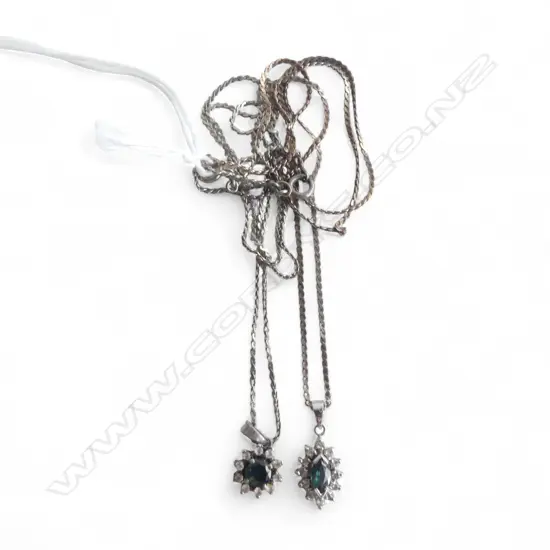 2 SAPHIRE & WHITE STONE PENDANTS ON SILVER CHAINS
