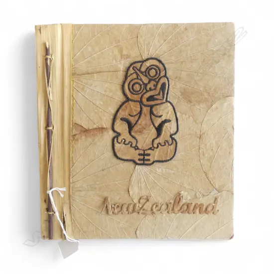 VINTAGE NEW ZEALAND TIKI ALBUM constructed of natural fibres. Fault to 'N' 280x255mm