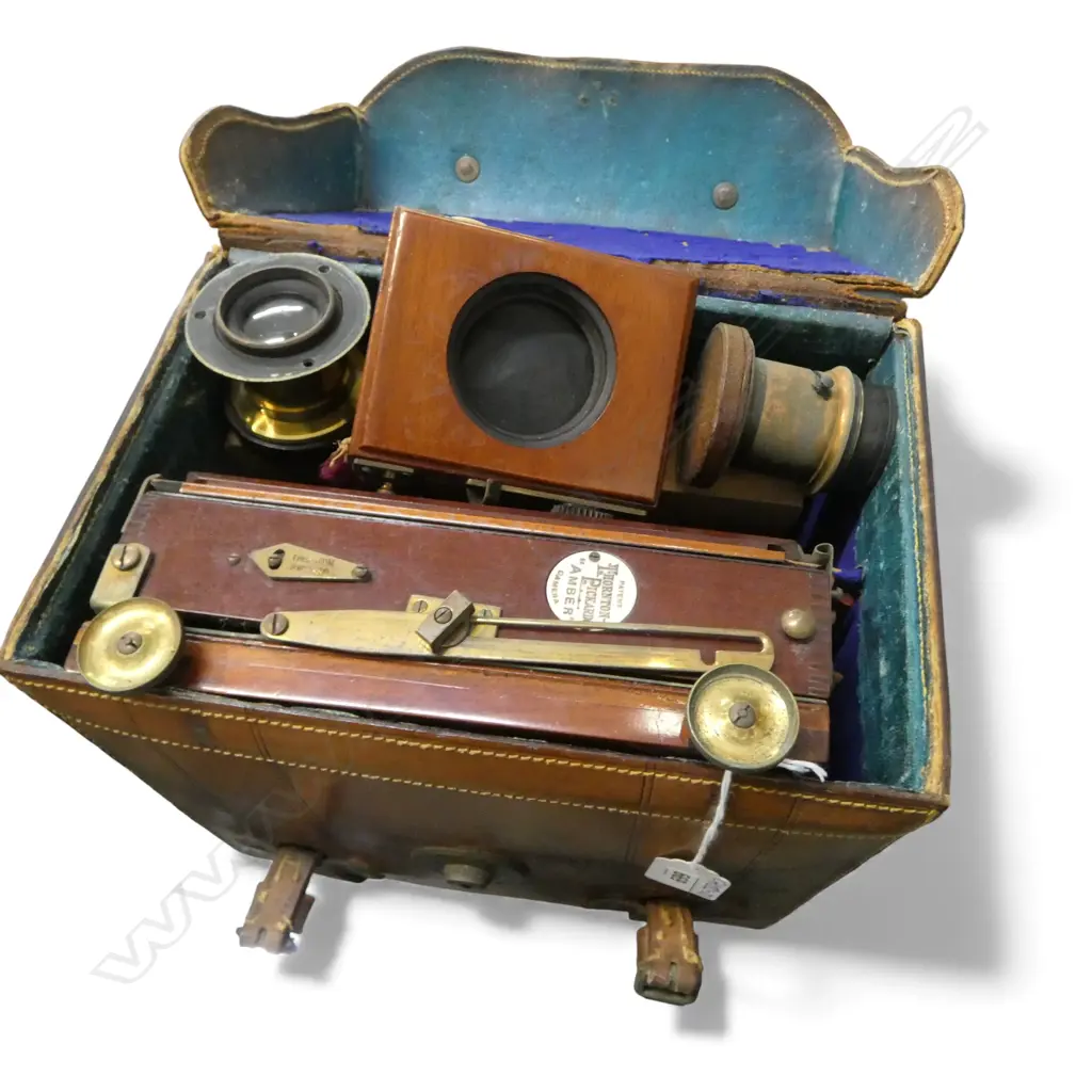 A c.1900 Thornton Pickard 'Amber' quarter plate folding mahogany camera with extras in leather case Image 1++