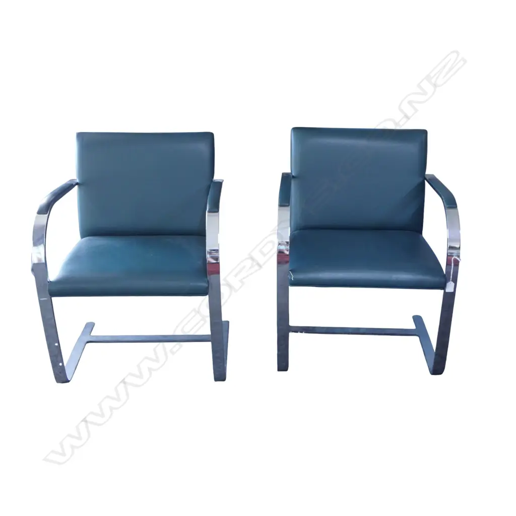 A pair of green leather and stainless steel cantilever chairs Image 1++
