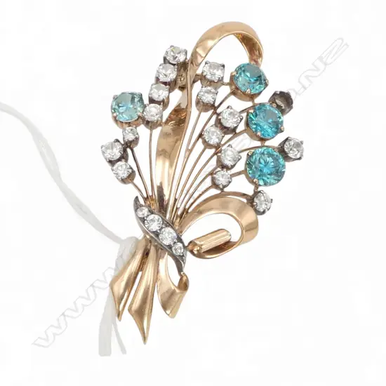 9CT GOLD BLUE AND WHITE ZIRCON BROOCH (one stone absent) with valuation